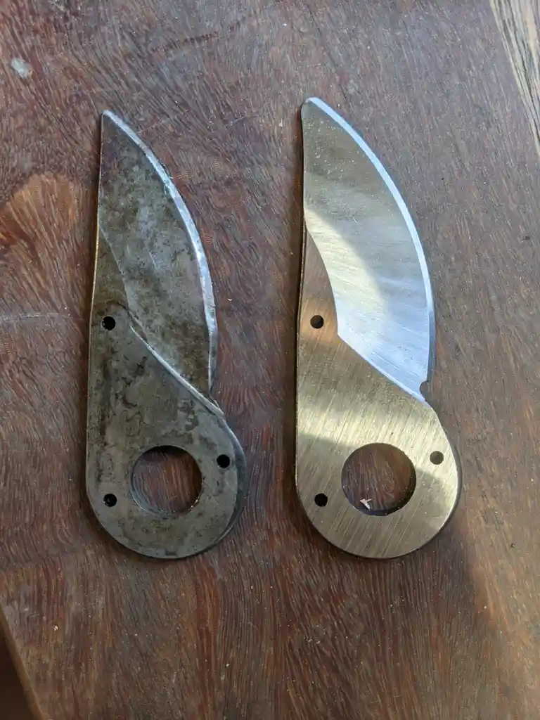 Two knife blades lie side by side on a wooden surface, one dull and tarnished, the other shiny and polished, with text…