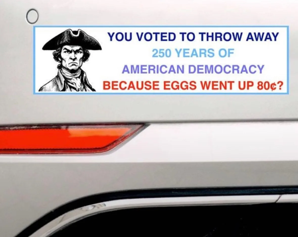 A white car bumper sticker features a stern black-and-white illustration of George Washington on the left. The text on the…