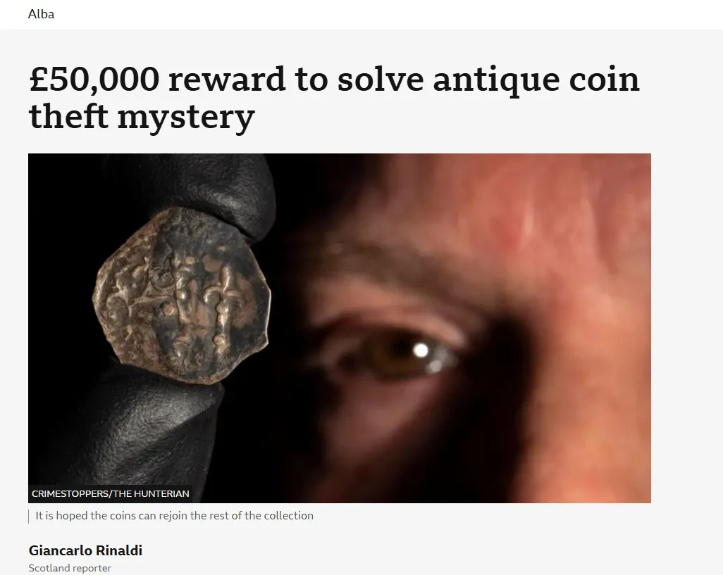 A close-up image shows a gloved hand holding an ancient, irregularly shaped coin with worn engravings, while a person's eye…