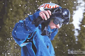 A person in a blue snowsuit and helmet is shown in a sequence of six images, starting by holding a snowball, then throwing…