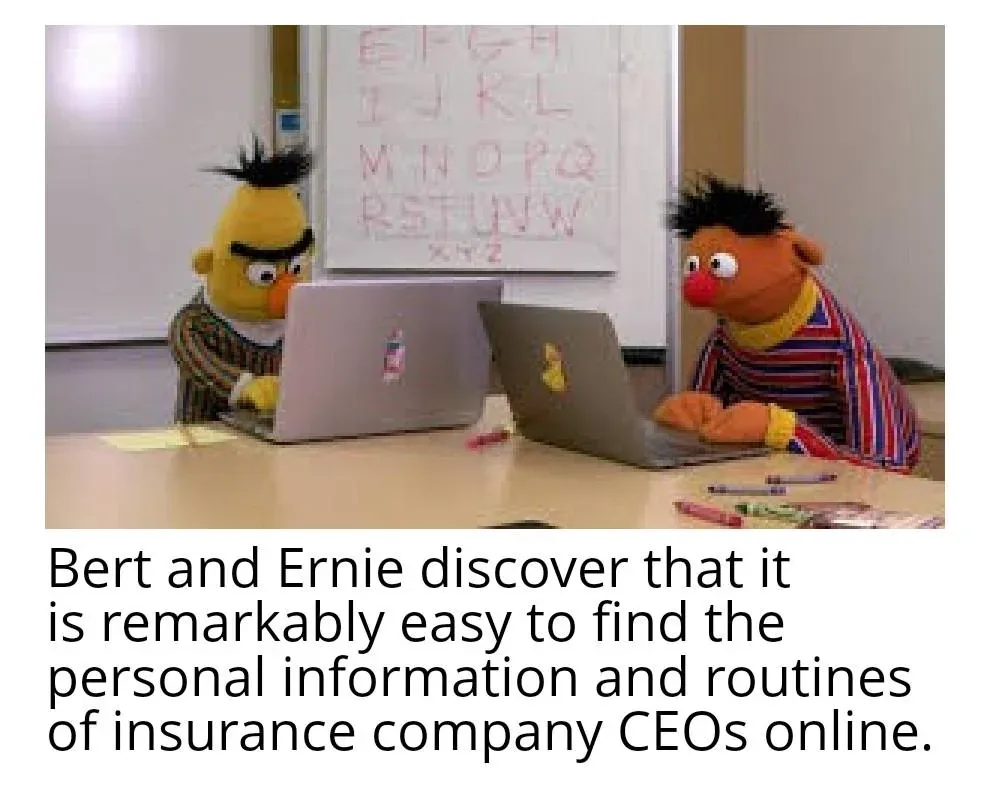 Two Muppet characters, Bert and Ernie, sit at a desk with laptops in front of them, in a classroom setting with an alphabet…