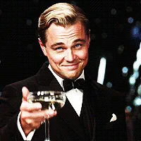 a gif of leonardo dicaprio in a tuxedo holding a martini glass and smiling, with the text 'i'm not a fan of the new movie'…