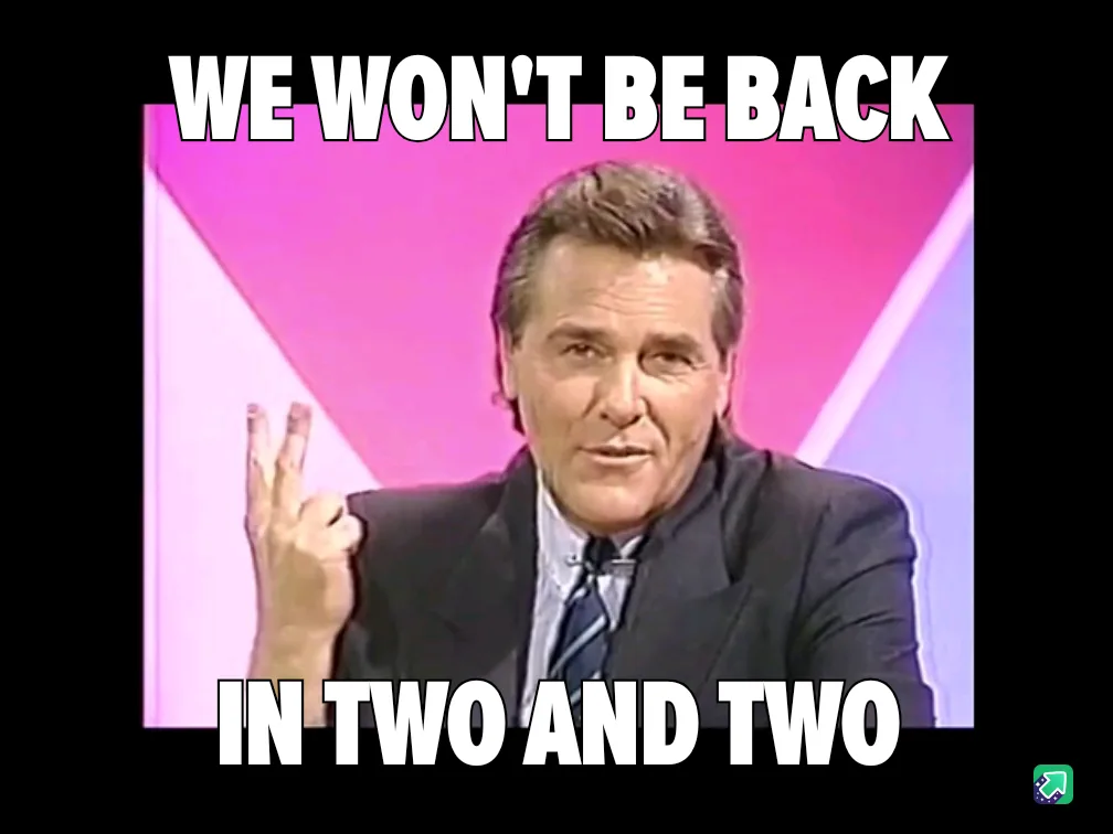 A man in a suit and tie, likely from a 1980s TV show, holds up two fingers on his right hand while looking directly at the…