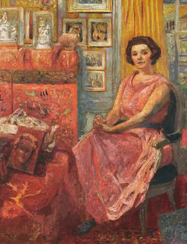 A vintage oil painting depicts a woman in a pink dress sitting in a chair within a room filled with ornate red furniture…