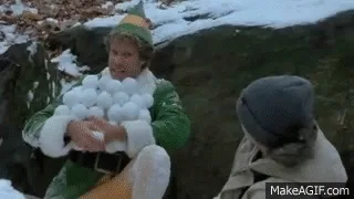 A sequence of six frames from the movie 'Elf' shows a young elf in a green outfit and hat holding a large bundle of…