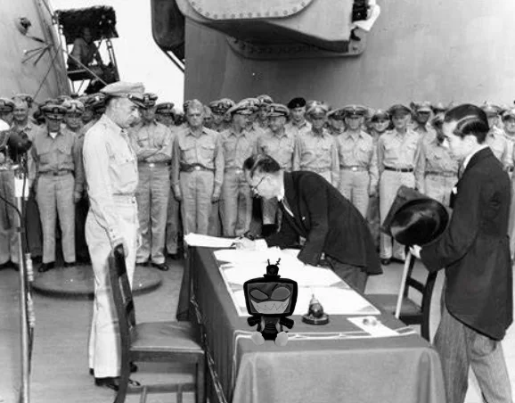 A black-and-white historical photo shows a man signing documents at a table on a ship's deck, surrounded by military…