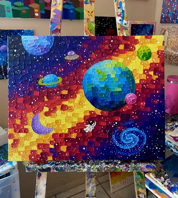 A vibrant, textured painting on canvas depicts a colorful galaxy with planets, a UFO, a crescent moon, and a small astronaut…