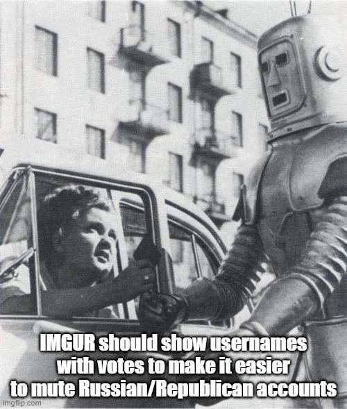 A black-and-white photo shows a man in a car reaching out to stop a large, vintage-style robot standing on the sidewalk. The…