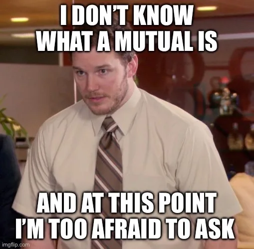 A man in a beige shirt and striped tie looks confused and slightly intimidated, standing in an office setting. The overlaid…