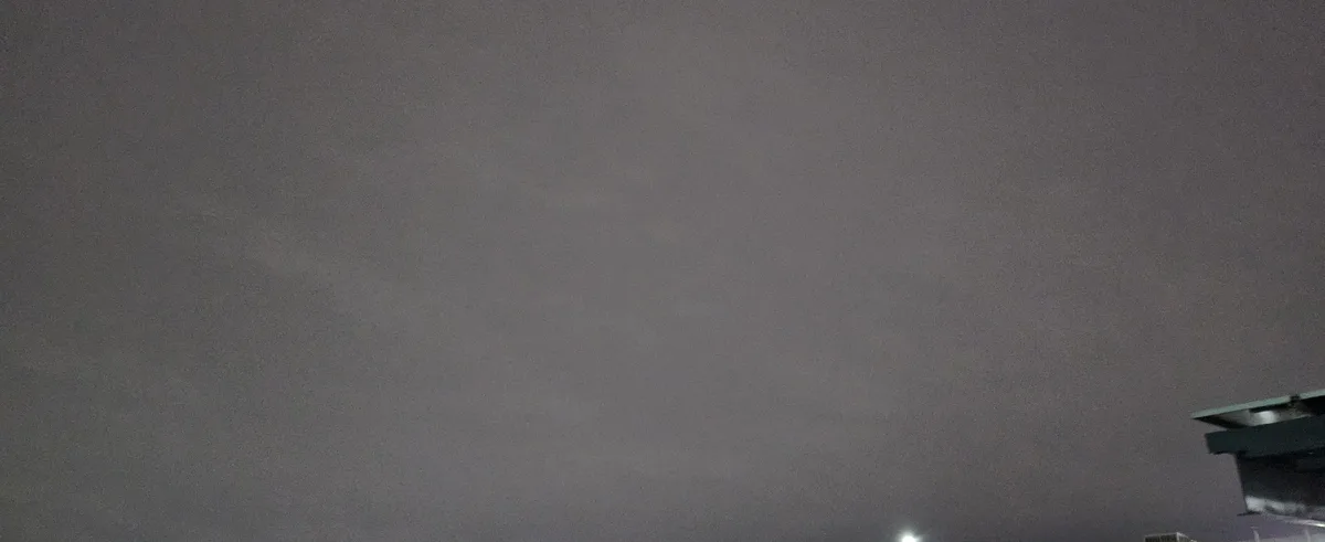A dark, foggy night sky with a faint light source and the top corner of a building visible. The overlaid text reads 'i'm not…