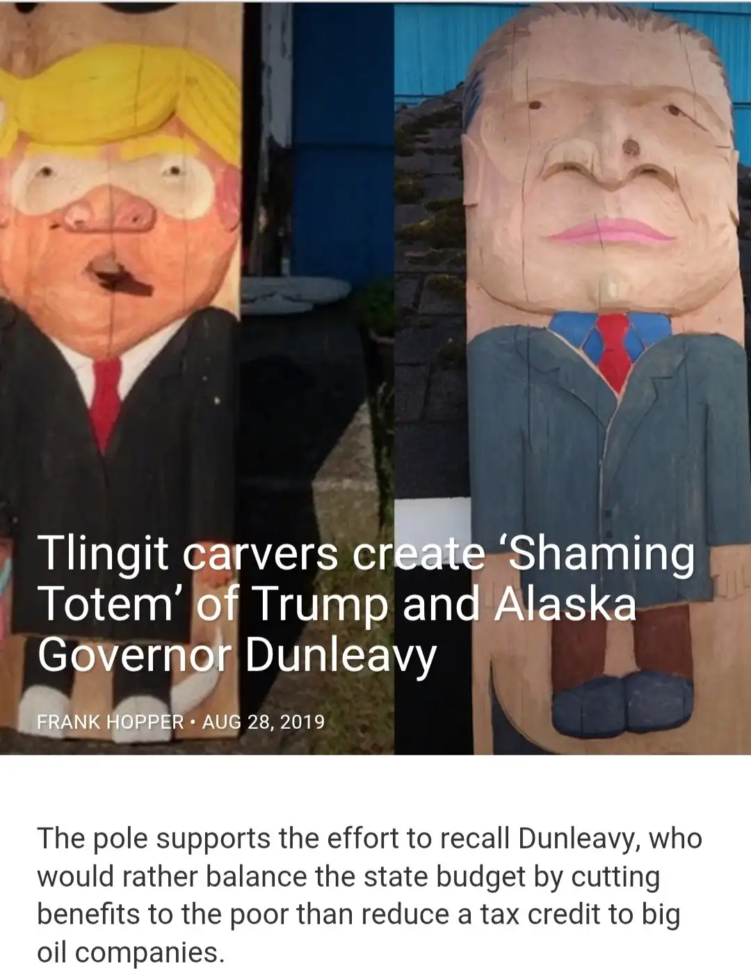 Two large wooden totem pole carvings side-by-side, one depicting a caricature of Donald Trump with a pig-like snout and…