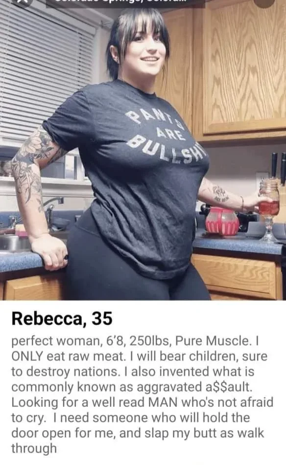 A woman with tattoos and a 'PANTS ARE BULLSHIT' t-shirt stands in a kitchen holding a drink. Text below her reads 'Rebecca…