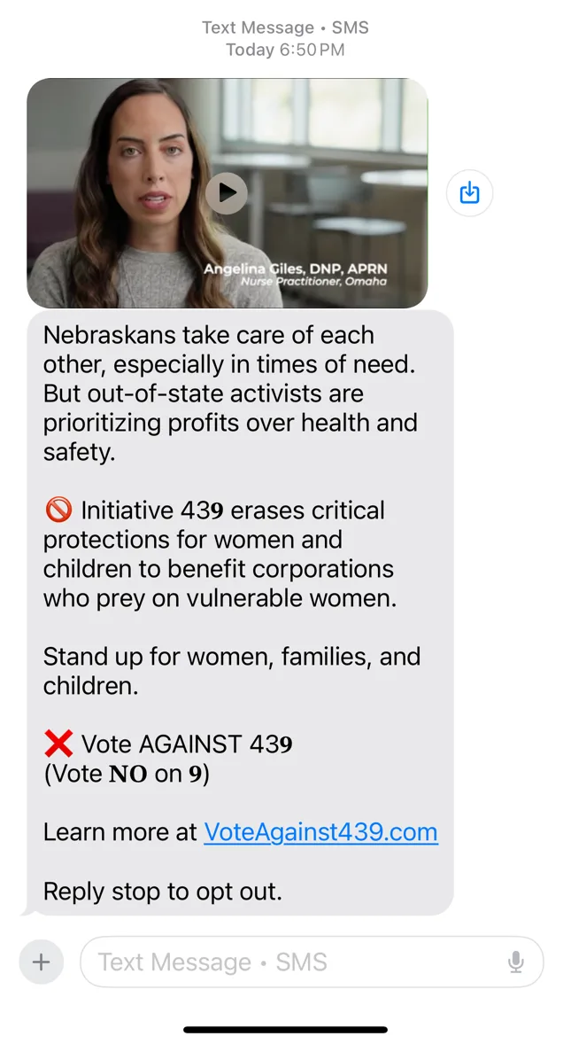 A screenshot of a text message from a political campaign, featuring a video thumbnail of a woman identified as Angelina…