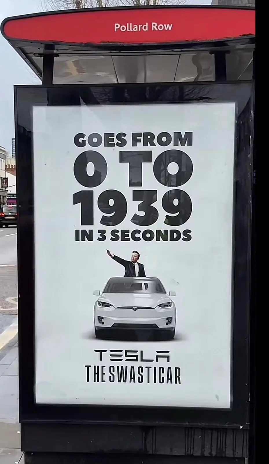 A bus stop advertisement for Tesla features a white Tesla SUV with Elon Musk waving from the roof. The ad claims the car…