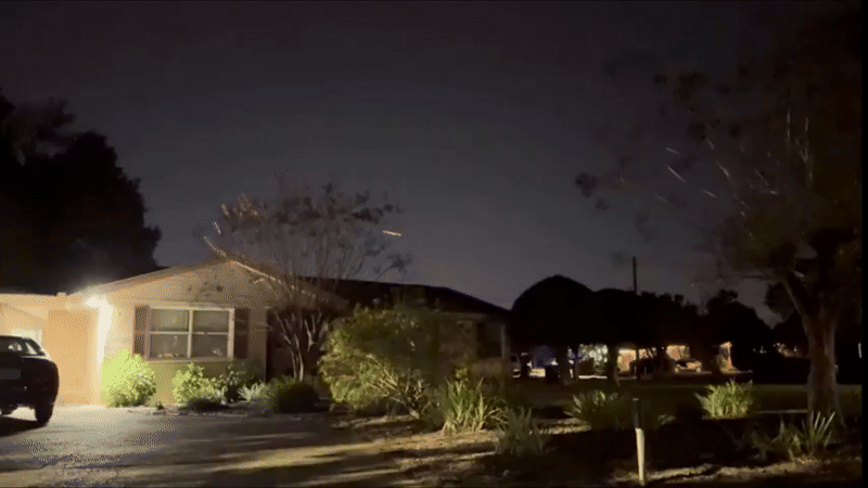 A six-panel sequence captures a bright meteor streaking across a dark suburban night sky, passing over rooftops and trees…