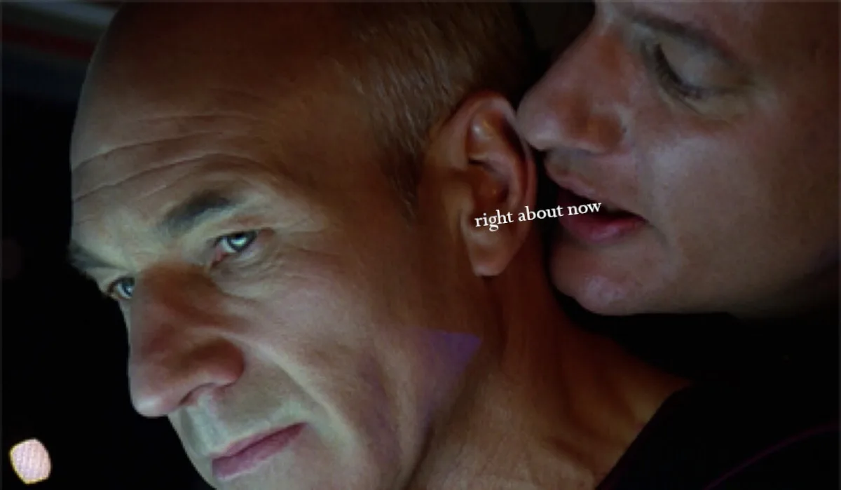 A close-up shot shows one man whispering into the ear of another man, who is looking forward with a serious expression. The…