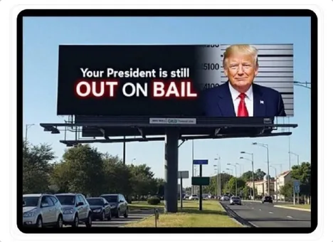 A large outdoor billboard displays a mugshot-style photo of Donald Trump on the right side, wearing a suit and red tie, with…