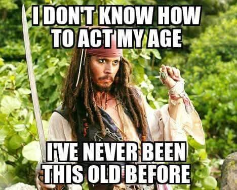 A man with long dreadlocks, a bandana, and a sword stands in a forest. He has a confused or bewildered expression. The text…