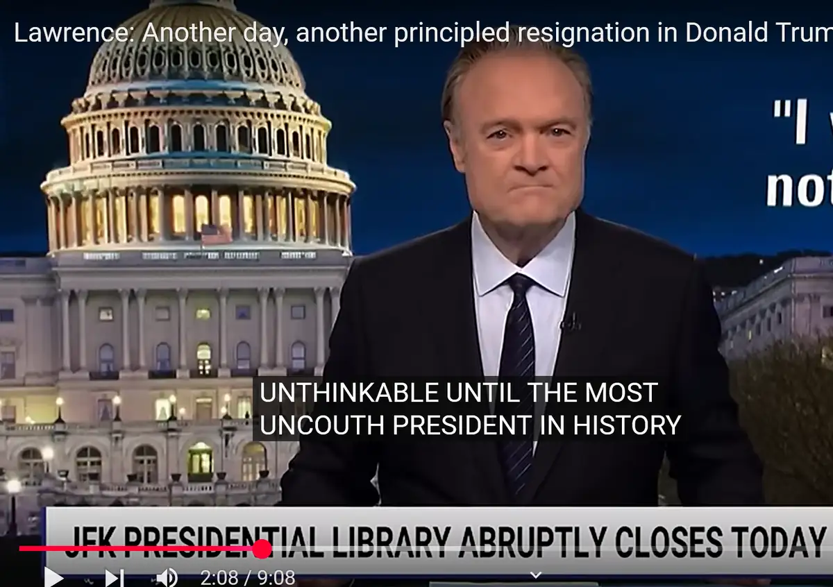 A screenshot of a news broadcast featuring a male news anchor in a suit with the U.S. Capitol building behind him. Overlaid…