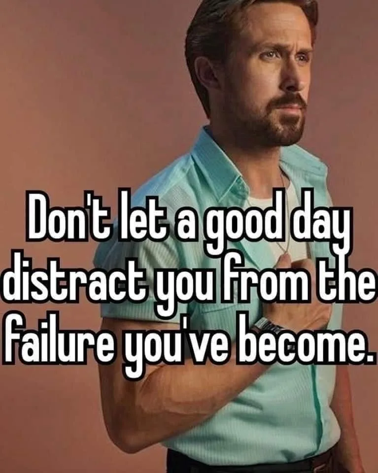 A man with a beard and short hair, wearing a light blue button-up shirt over a white undershirt, stands against a solid…