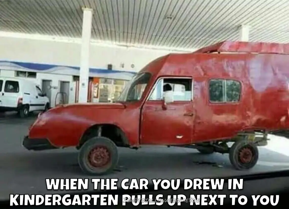 A heavily modified, rusty red vehicle with a boxy, cartoonish shape and mismatched wheels is parked at a gas station. The…
