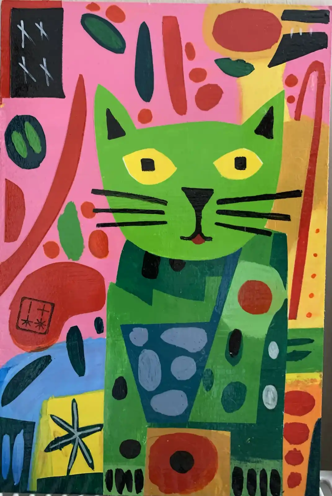 A colorful, abstract painting features a stylized green cat with yellow eyes and black markings, set against a vibrant…