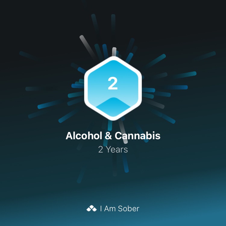 A digital badge graphic shows a blue hexagon with the number '2' inside, surrounded by radiating lines. Below it, text reads…