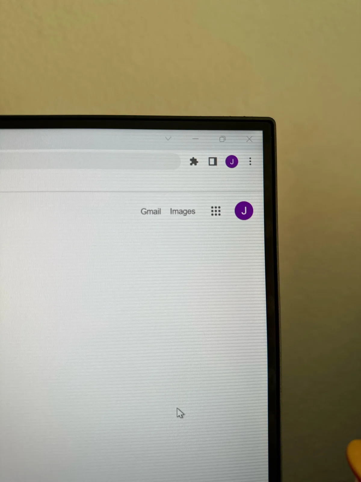 A close-up photo of a computer monitor displaying a blank Google Chrome browser window with the Gmail and Images tabs…