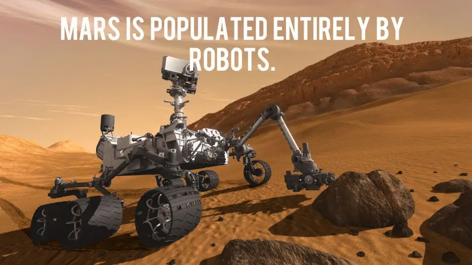 An image of a Mars rover on the red planet's surface, surrounded by rocky terrain and sand dunes under a hazy orange sky…