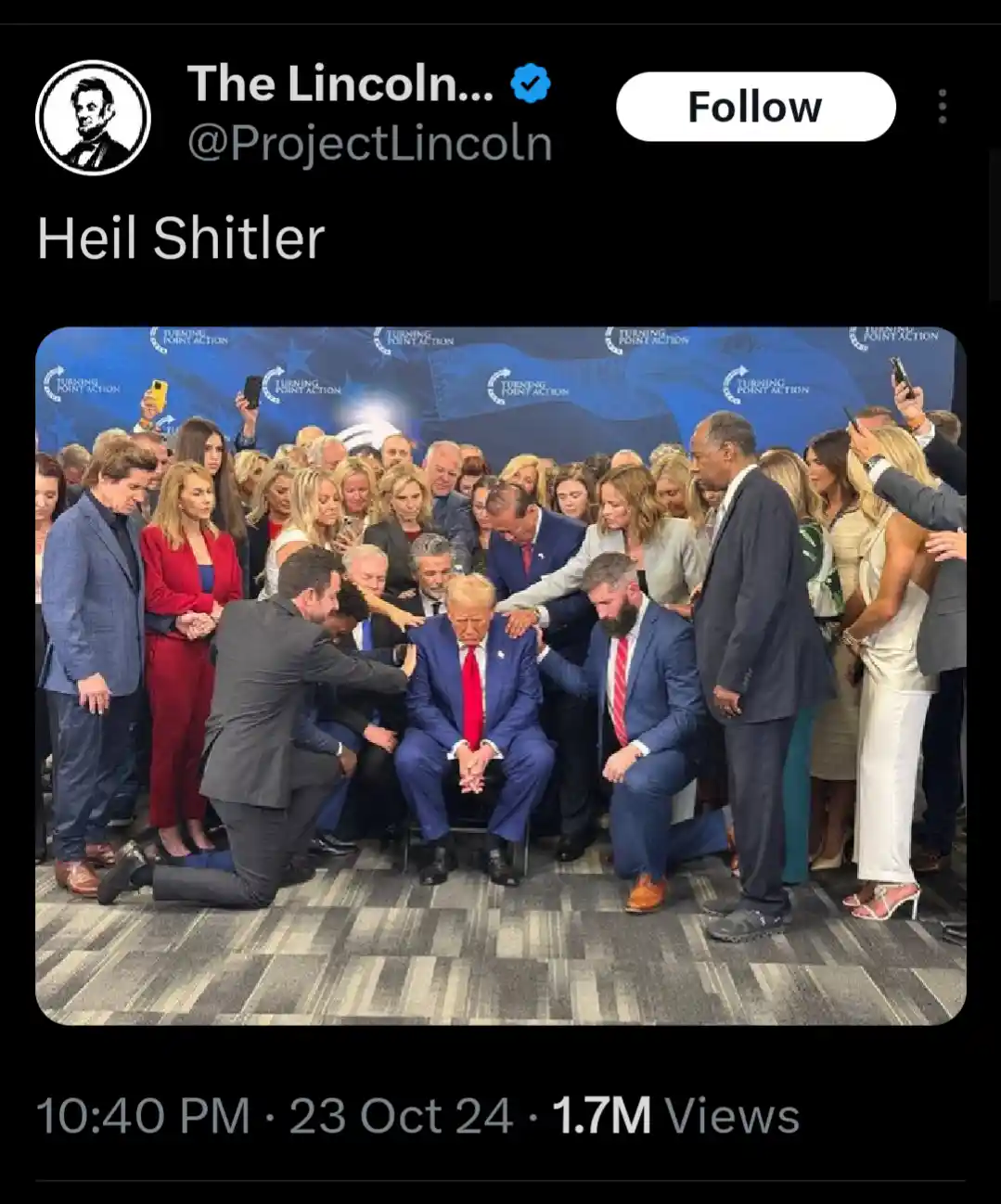 A screenshot of a tweet from @ProjectLincoln showing Donald Trump seated while multiple people kneel around him, some…