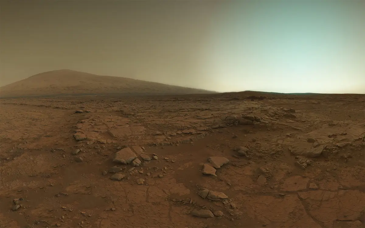 A panoramic view of the barren, reddish Martian landscape with rocky terrain and a hazy sky, overlaid with the text 'i'm not…