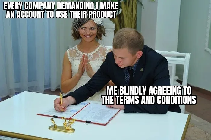 A man in a suit is signing documents at a white table, with a golden swan-shaped paperweight nearby. Behind him, a woman in…