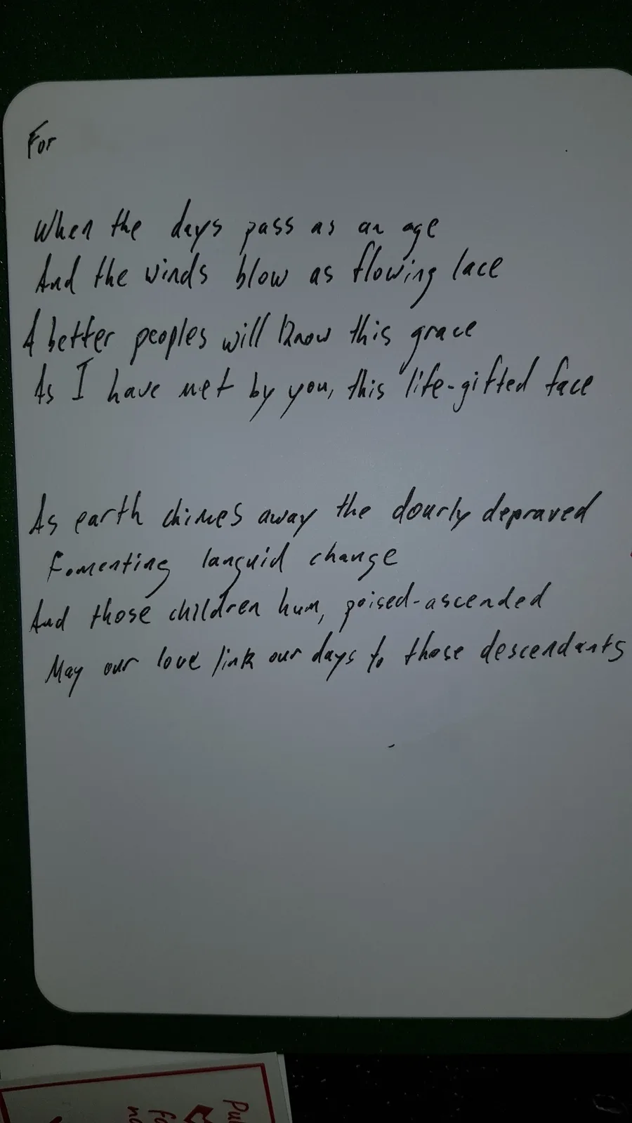 A handwritten note on a white card with black ink, written in a poetic, somewhat awkward style, appears to be a sentimental…