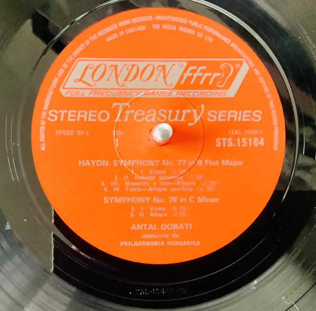 A close-up of an orange London Records label on a vinyl record from the Stereo Treasury Series, featuring Haydn's Symphony…