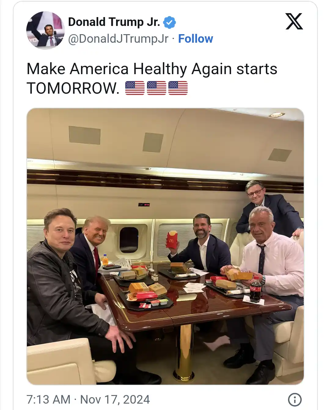 A screenshot of a tweet by Donald Trump Jr. shows a group of men, including Elon Musk and Donald Trump, seated around a…