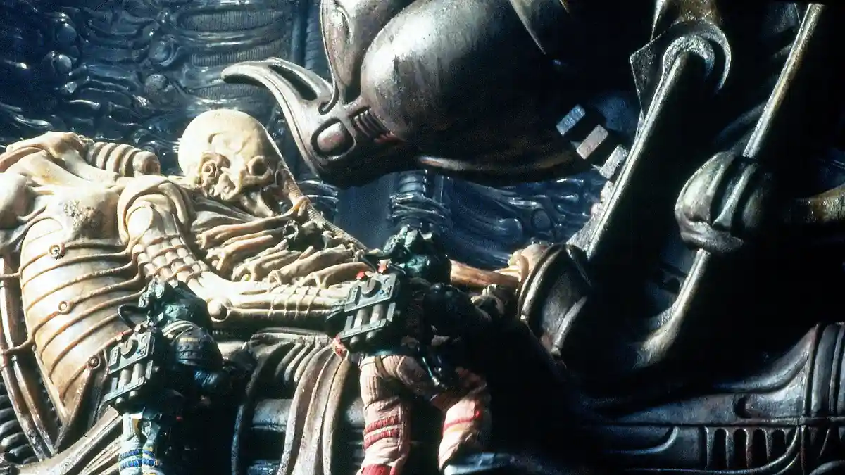 A still from the movie 'Alien' shows a large, biomechanical alien creature looming over a human astronaut who is lying on…