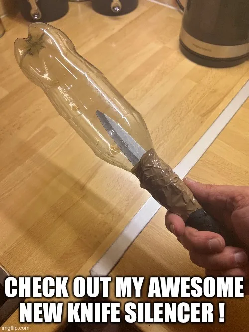 A hand holds a kitchen knife with its blade inserted into the neck of a clear plastic bottle, which is taped to the handle…