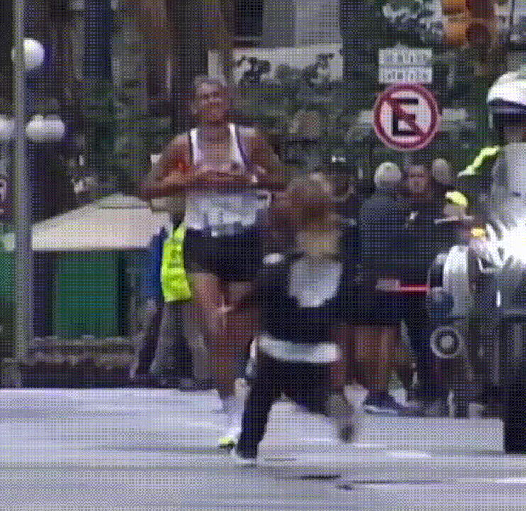 A sequence of six images shows a male marathon runner in a white tank top and black shorts running down a city street, with…