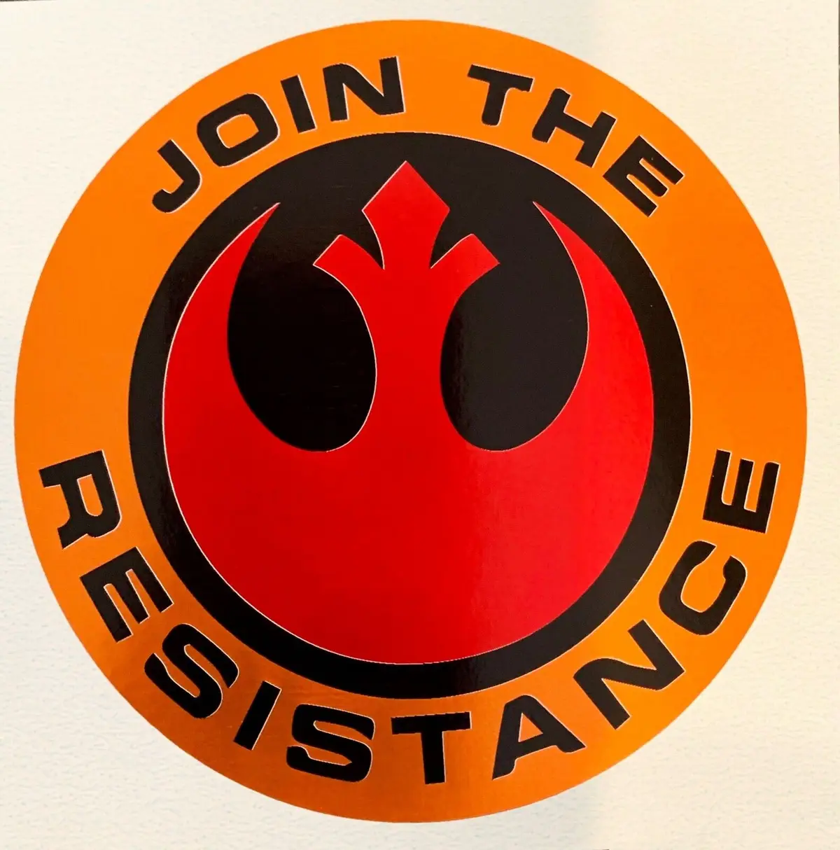 A circular sticker features the red and black Resistance symbol from Star Wars, surrounded by the text 'JOIN THE RESISTANCE'…
