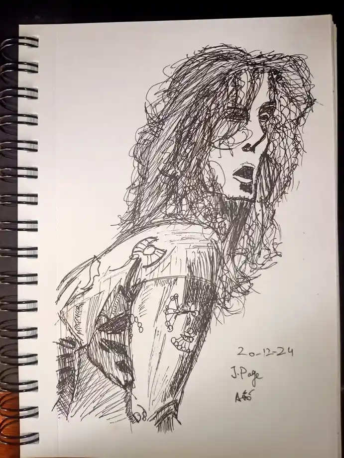 A black-and-white sketch in a spiral-bound notebook shows a stylized, expressive portrait of a person with long, messy hair…