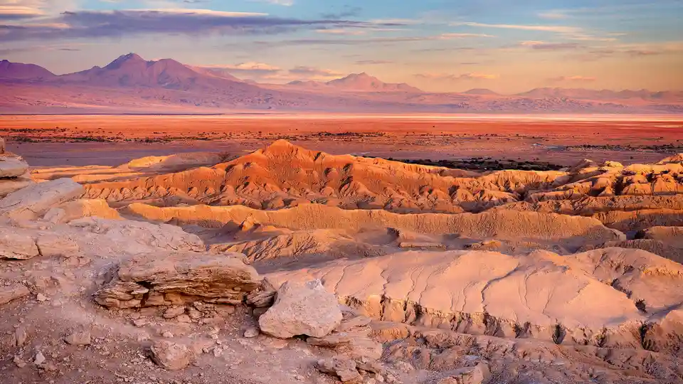 In the Atacama Desert's Cordillera de la Sal mountain range, the lunar-like landscape of Valle de la Luna converges with the…
