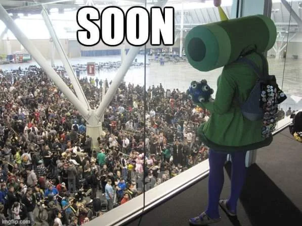 A person in a green Yoshi costume with a large green tube on their back stands on a balcony overlooking a massive, crowded…