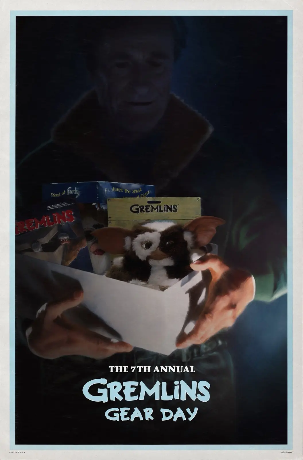 A person holds open a box containing a Gremlins plush toy, with other toy boxes visible behind it. A faded, menacing face…