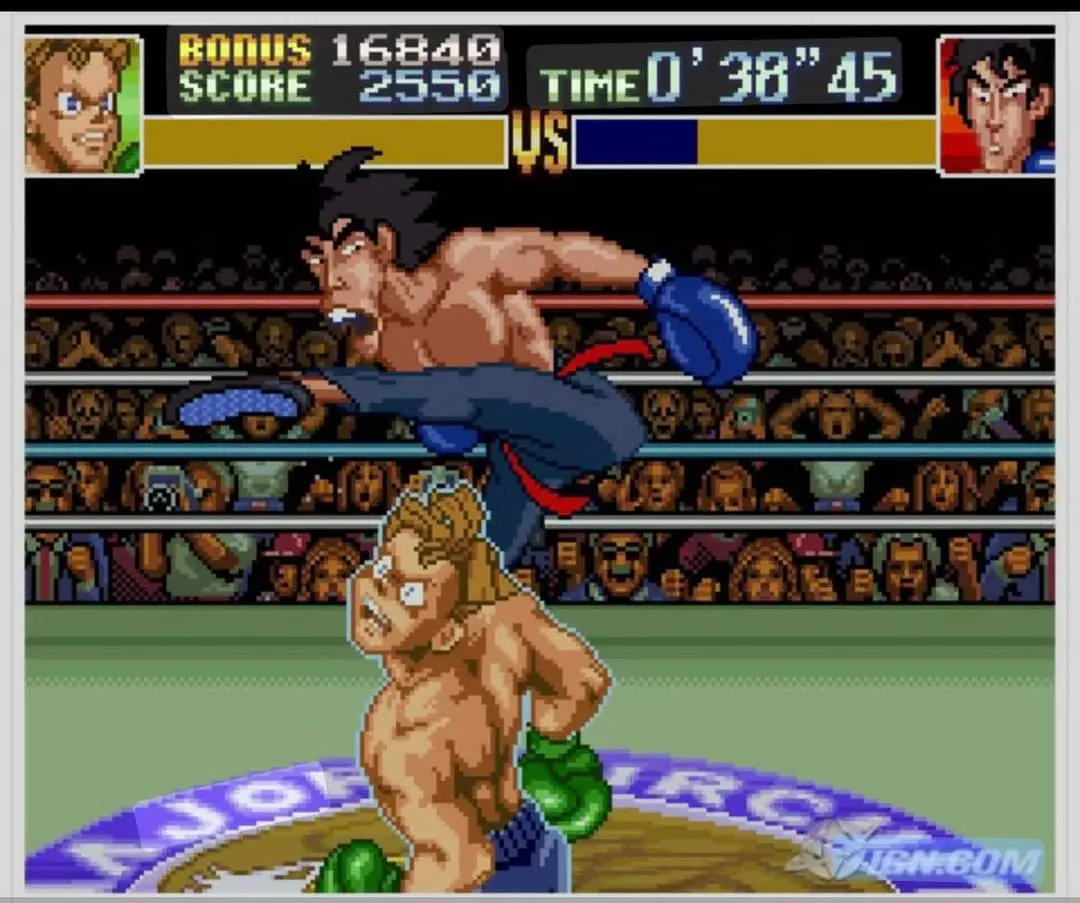 A pixelated screenshot from a classic 16-bit boxing video game shows one fighter mid-air delivering a kick to another…