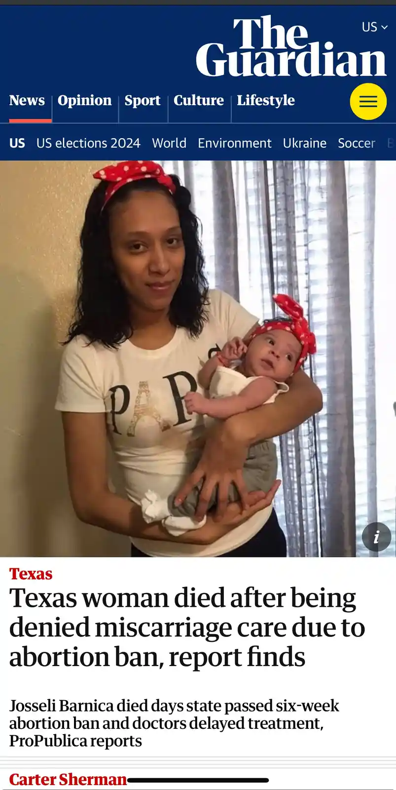 A screenshot of a The Guardian news article shows a woman holding a baby, both wearing matching red polka-dot headbands. The…