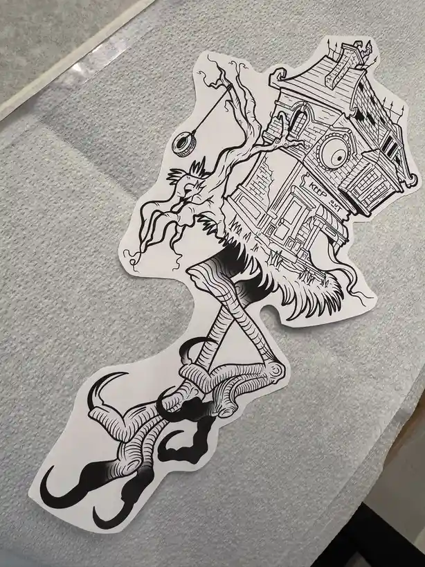 A black-and-white line art sticker depicts a haunted house with an eye on its front, perched atop a grotesque, skeletal…