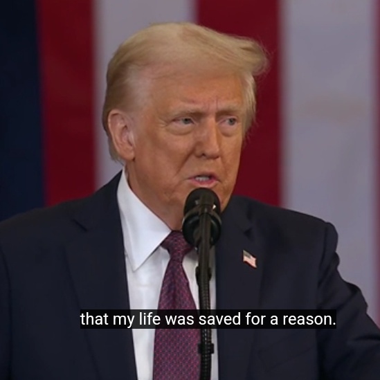 A close-up image of Donald Trump speaking at a podium with an American flag in the background. He is wearing a dark suit…