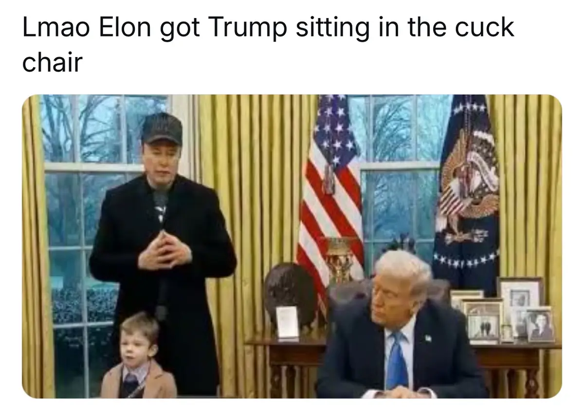 The image shows a man in a black coat and cap standing with his hands clasped, a young boy in a suit sits in front of him…