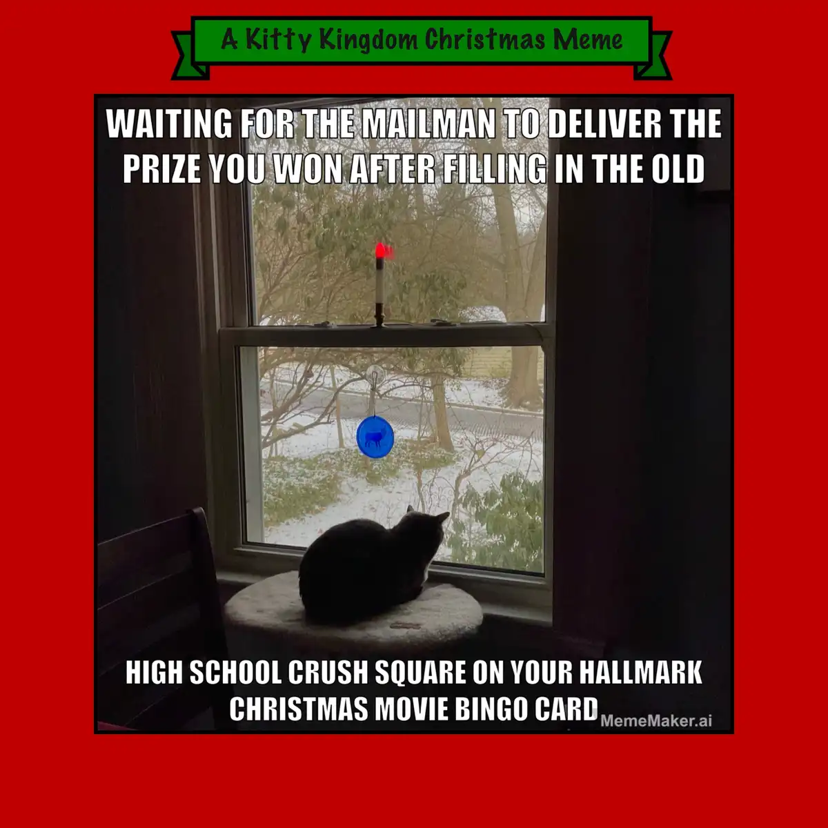 A black cat sits on a round cushioned stool by a window, looking out at a snowy yard with bare trees. A red candle is lit on…