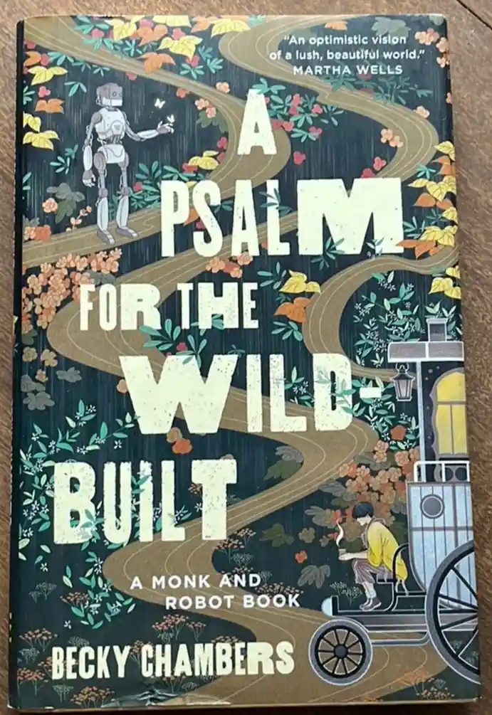 The image shows the book cover of 'A Psalm for the Wild-Built' by Becky Chambers, featuring an illustrated robot and a monk…